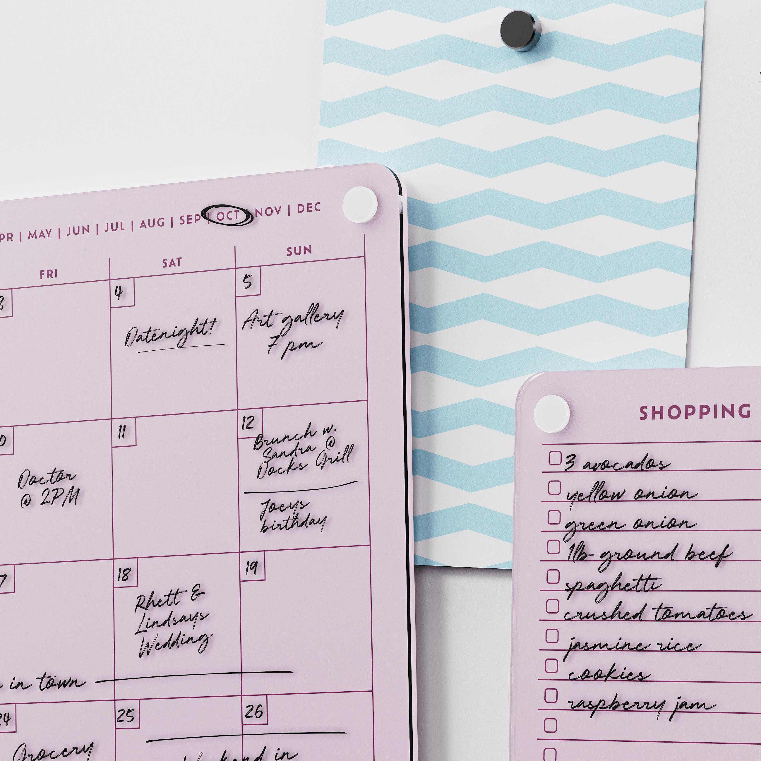 Close-up of the Ballet pink monthly calendar and shopping list boards with handwritten plans and groceries